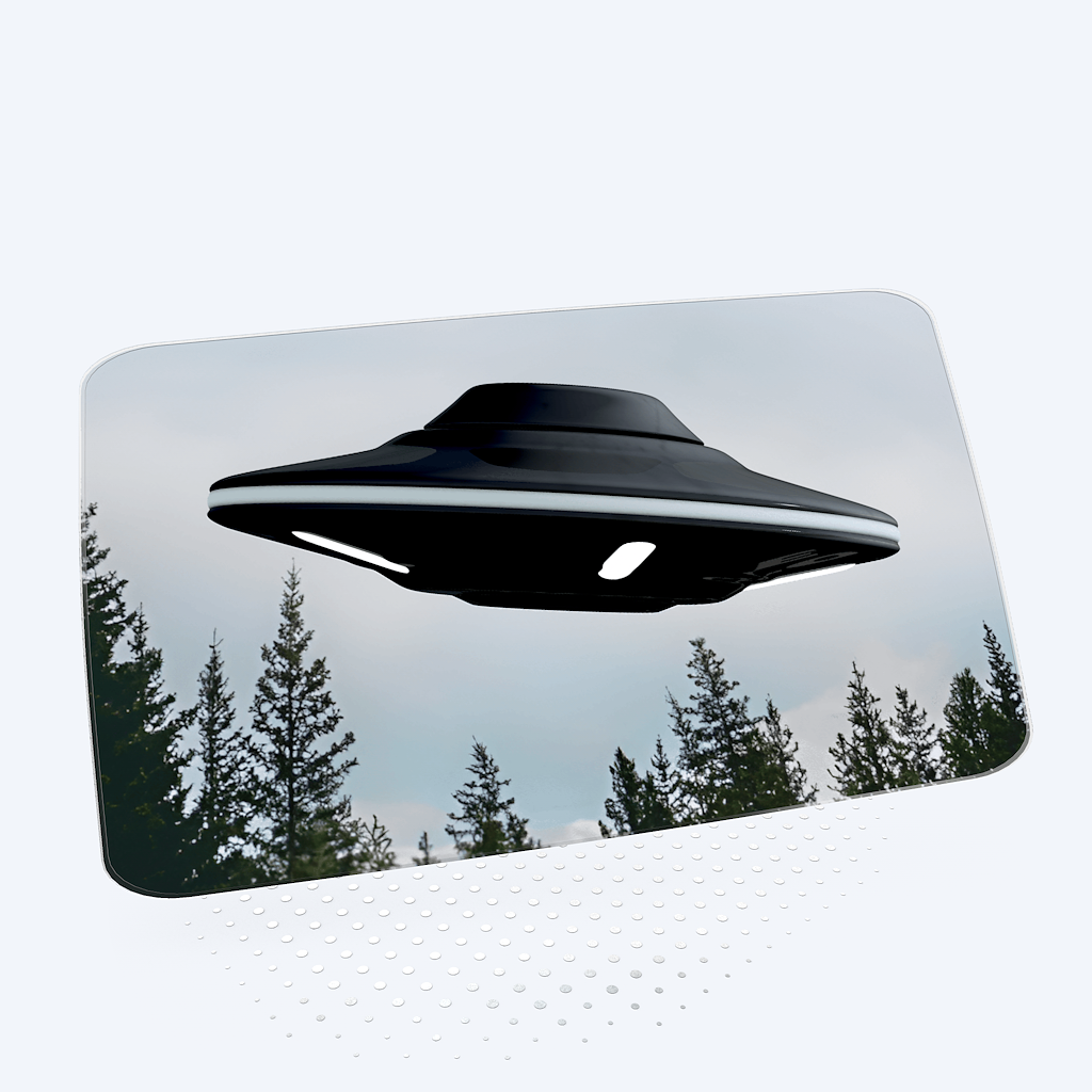 A stylized animated screensaver of a glowing UFO with a beam of light over a mountain silhouette